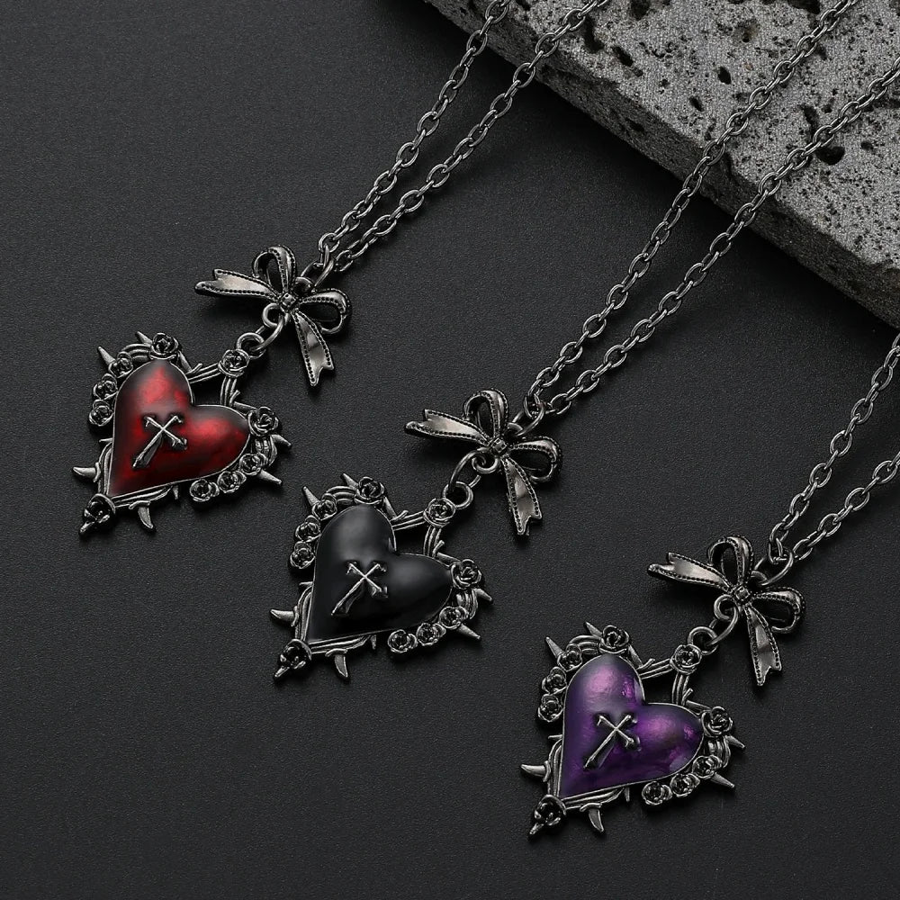 gothic heart necklace, thorn heart pendant, heart cross necklace, gothic bow necklace, red heart gothic jewelry, black heart pendant, purple gothic necklace, dark romantic jewelry, silver rose thorn necklace, gothic Valentine jewelry, vintage punk necklace, Y2K gothic accessories, gothic Lolita jewelry, vampire inspired necklace, unisex gothic jewelry, heart with cross necklace, alternative fashion jewelry, romantic goth necklace, silver bow pendant, dark coquette jewelry