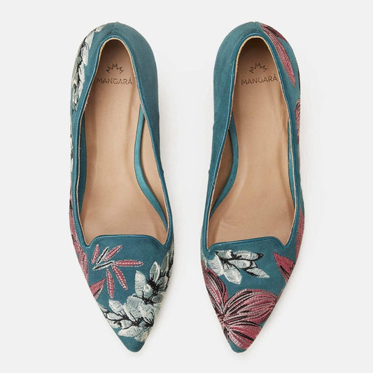 Pair of teal pointed-toe shoes with floral embroidery on a white background