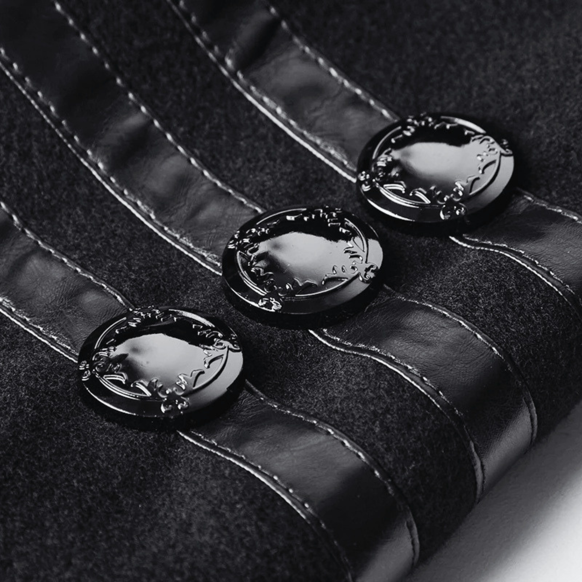 Man wearing black gothic military long coat with double breasted metal buttons and structured high collar