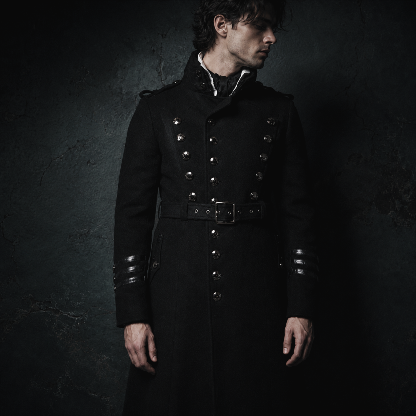 Man wearing black gothic military long coat with double breasted metal buttons and structured high collar