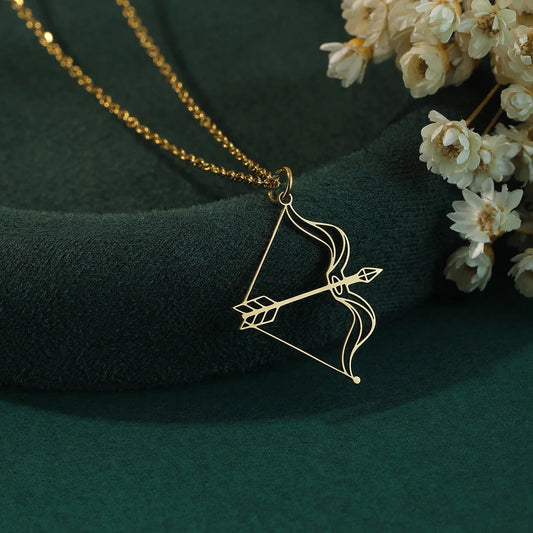gold bow pendant, arrow charm necklace, openwork archer jewellery, cupid arrow pendant, romantic archery necklace, delicate bow necklace, fairytale arrow charm, love weapon jewellery, golden archer accessory, bow and arrow charm, slim pendant necklace, fantasy bow jewellery, minimalist archer pendant, romantic gold necklace, once upon a broken heart, Evangeline, jacks