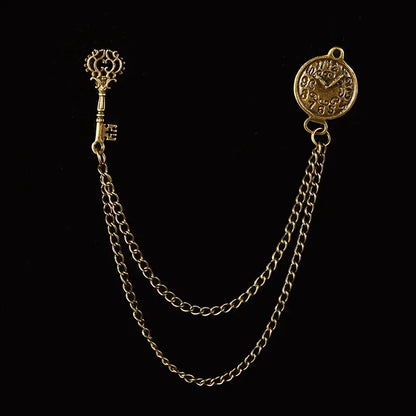 antique key lapel chain, caraval, legendary, dante santos, legend, julian santos, lovezaqua, pocket watch fob accessory, gold suit chain brooch, double draped chain pin, round medallion lapel pin, vintage key suit jewelry, gentleman waistcoat chain, bird star brooch detail, old clock inspired accessory, formal jacket chain pin, decorative fob brooch, antique watch chain style, vintage shirt badge, historical mens accessory
