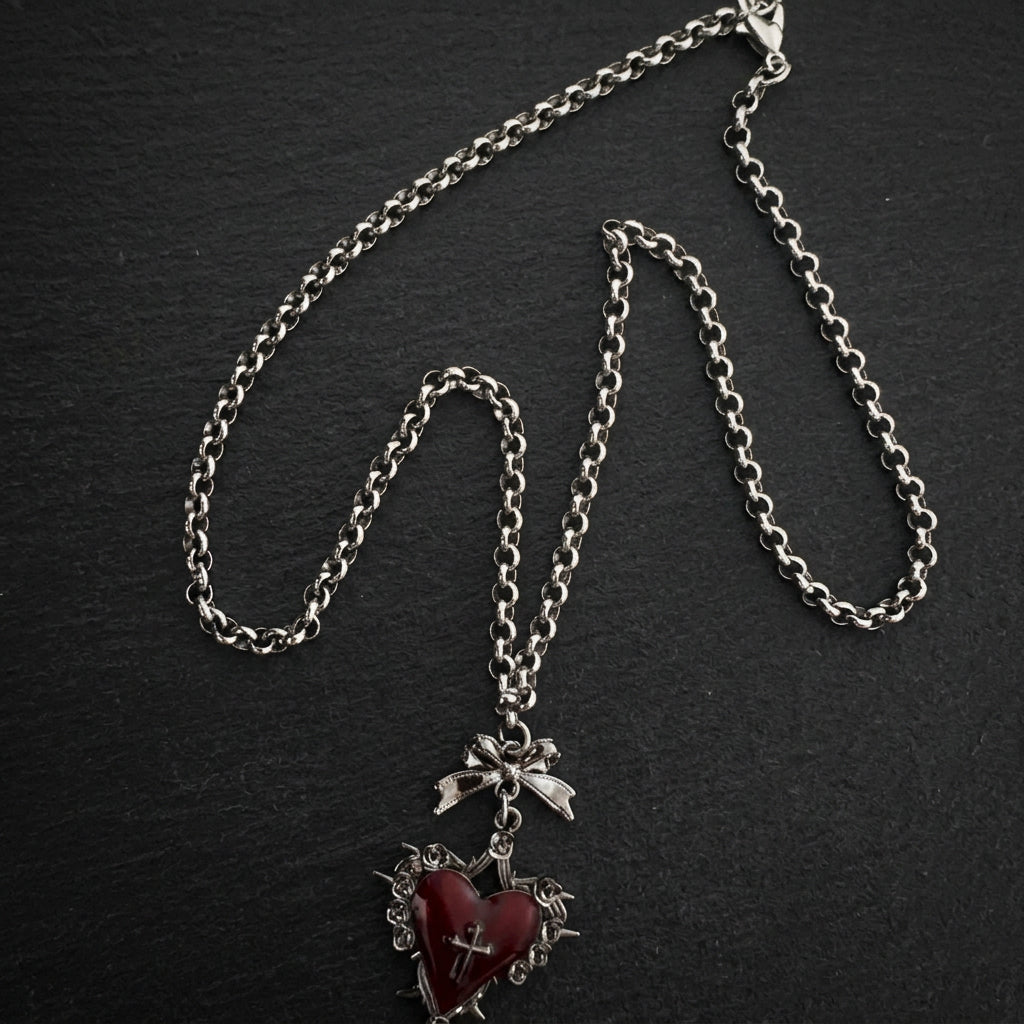 gothic heart necklace, thorn heart pendant, heart cross necklace, gothic bow necklace, red heart gothic jewelry, black heart pendant, purple gothic necklace, dark romantic jewelry, silver rose thorn necklace, gothic Valentine jewelry, vintage punk necklace, Y2K gothic accessories, gothic Lolita jewelry, vampire inspired necklace, unisex gothic jewelry, heart with cross necklace, alternative fashion jewelry, romantic goth necklace, silver bow pendant, dark coquette jewelry