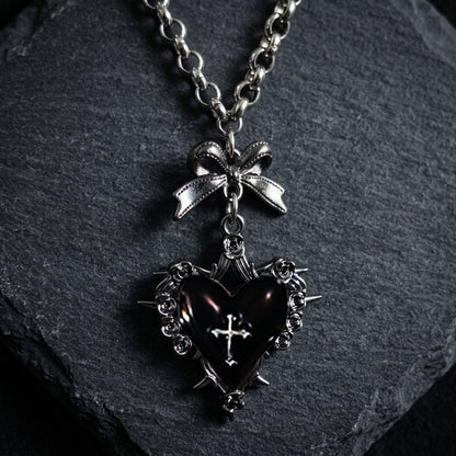 gothic heart necklace, thorn heart pendant, heart cross necklace, gothic bow necklace, red heart gothic jewelry, black heart pendant, purple gothic necklace, dark romantic jewelry, silver rose thorn necklace, gothic Valentine jewelry, vintage punk necklace, Y2K gothic accessories, gothic Lolita jewelry, vampire inspired necklace, unisex gothic jewelry, heart with cross necklace, alternative fashion jewelry, romantic goth necklace, silver bow pendant, dark coquette jewelry
